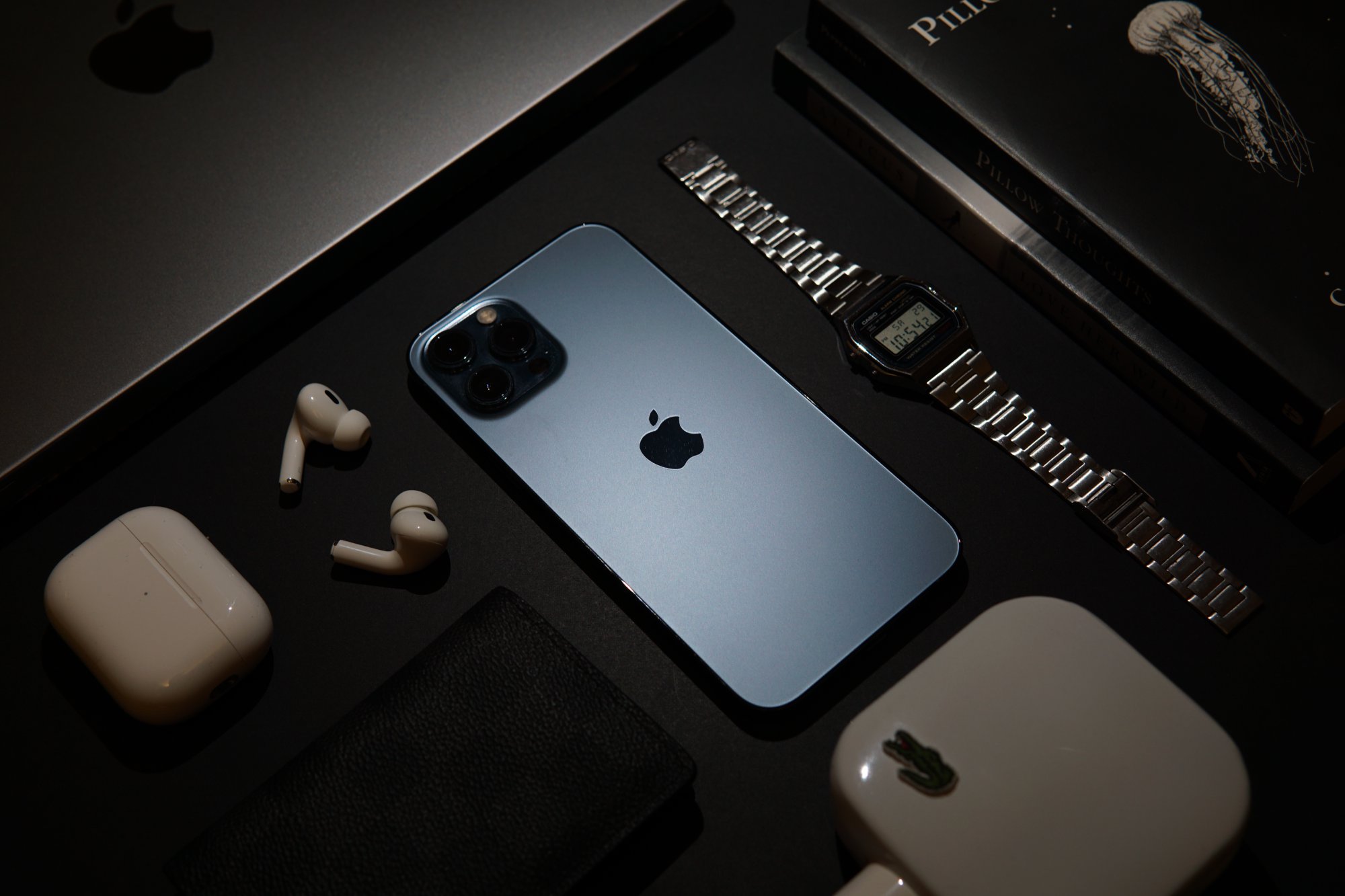 Tech flatlay with iPhone, AirPods and Casio watch